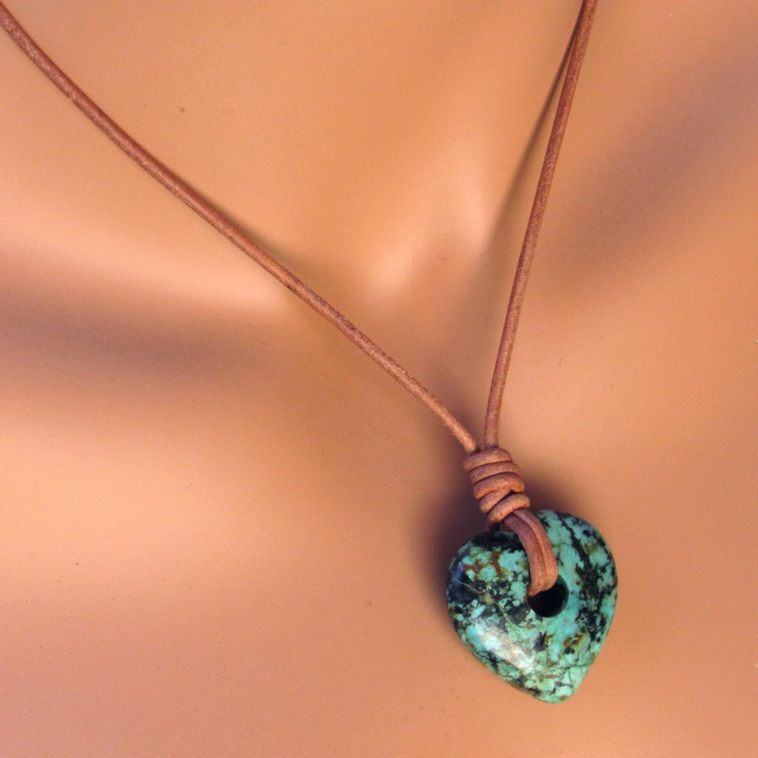 African Turquoise gemstone heart on natural leather with copper clasp