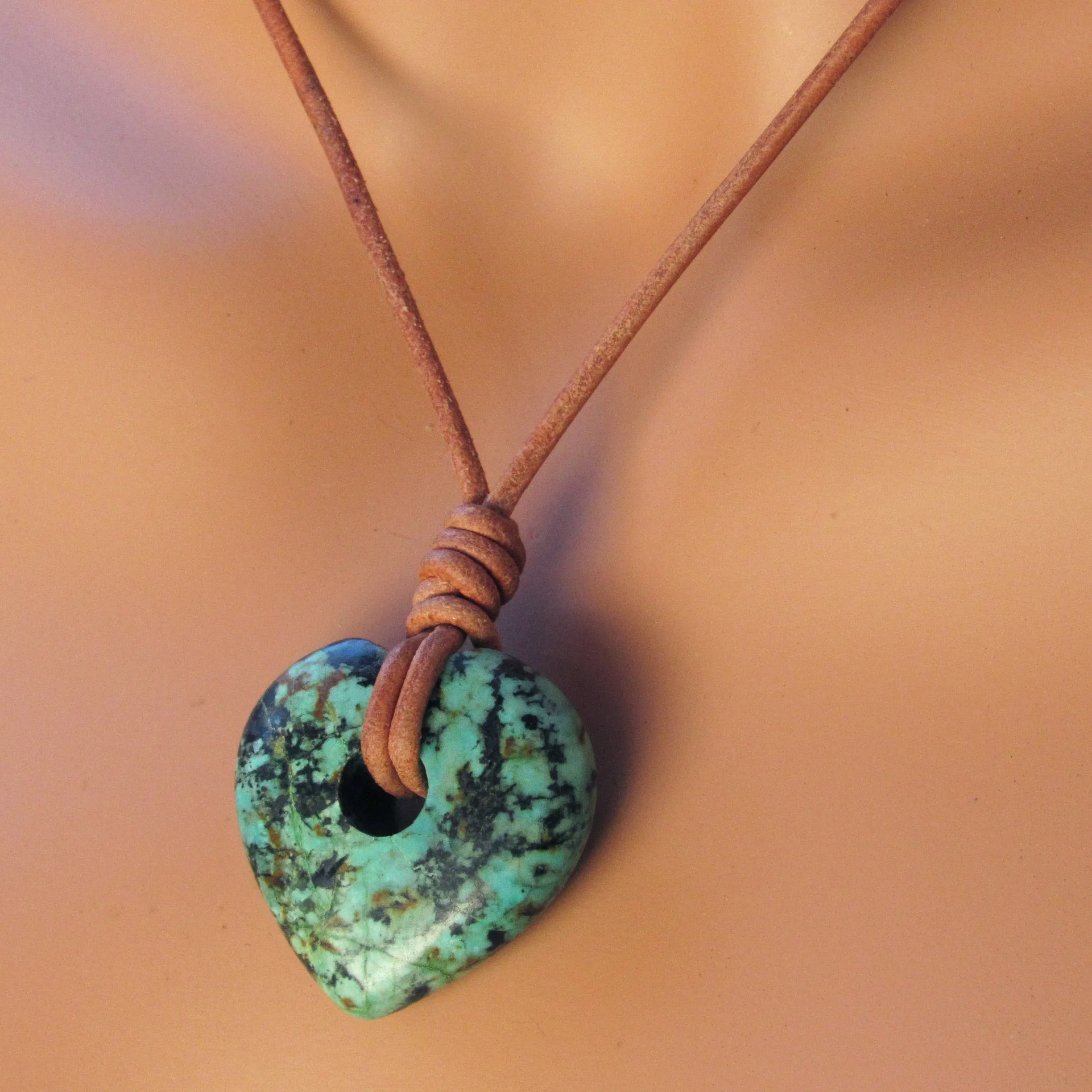 African Turquoise gemstone heart on natural leather with copper clasp